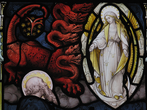 St. John sees the battle between the Dragon and the Woman clothed with the sun.